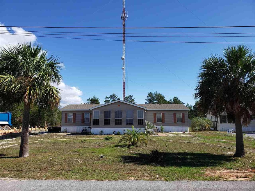 Front of home wit two beautiful palm trees