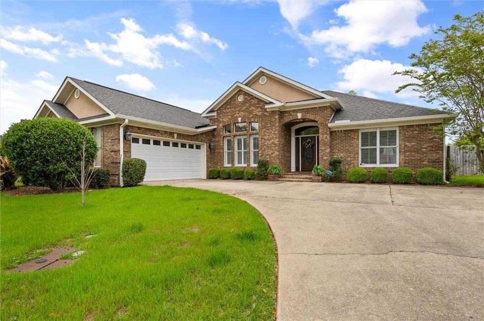 Ranch-style home featuring a front yard, a garage,