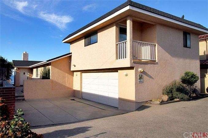 Street view of beach front home showing attached 2