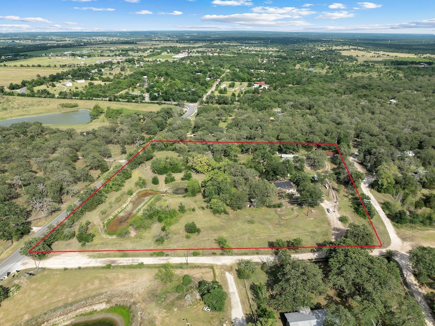 Aerial view of property and surrounding area with
