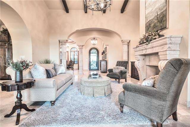 Dramatic living area with soaring ceilings, arched