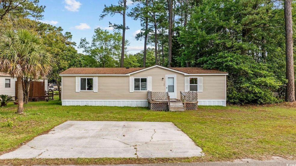 Manufactured / mobile home with a front lawn and a patio
