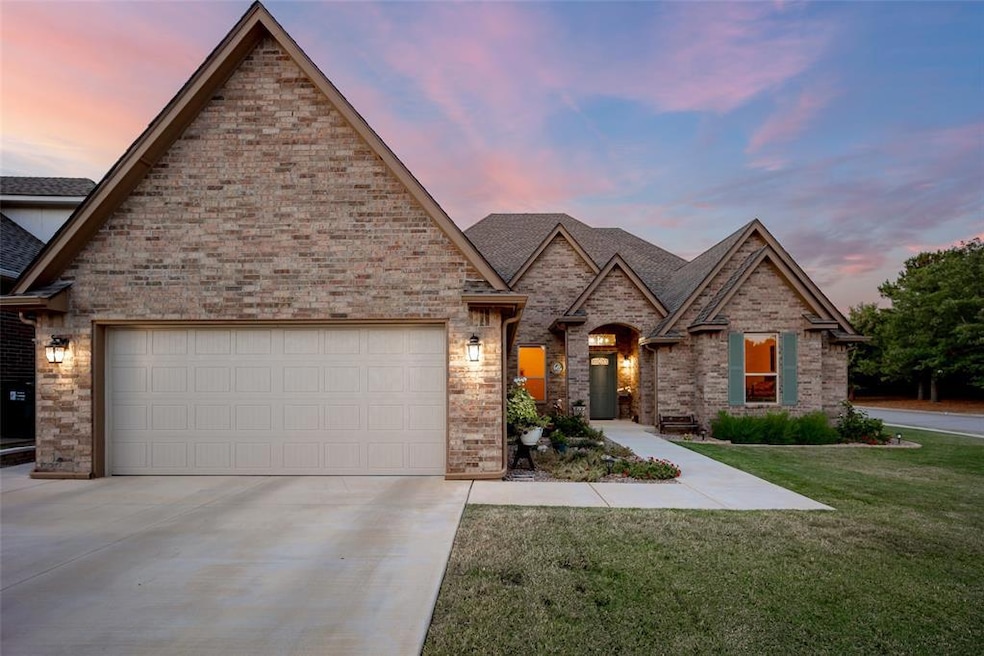 French country inspired facade with driveway, an a