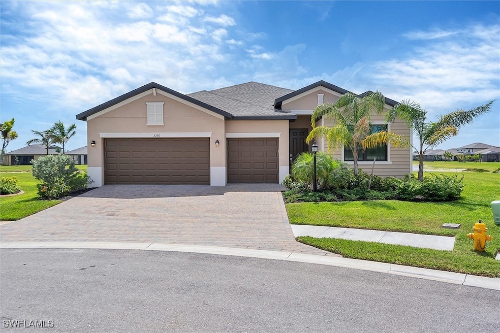 Single story home with stucco siding, driveway, a