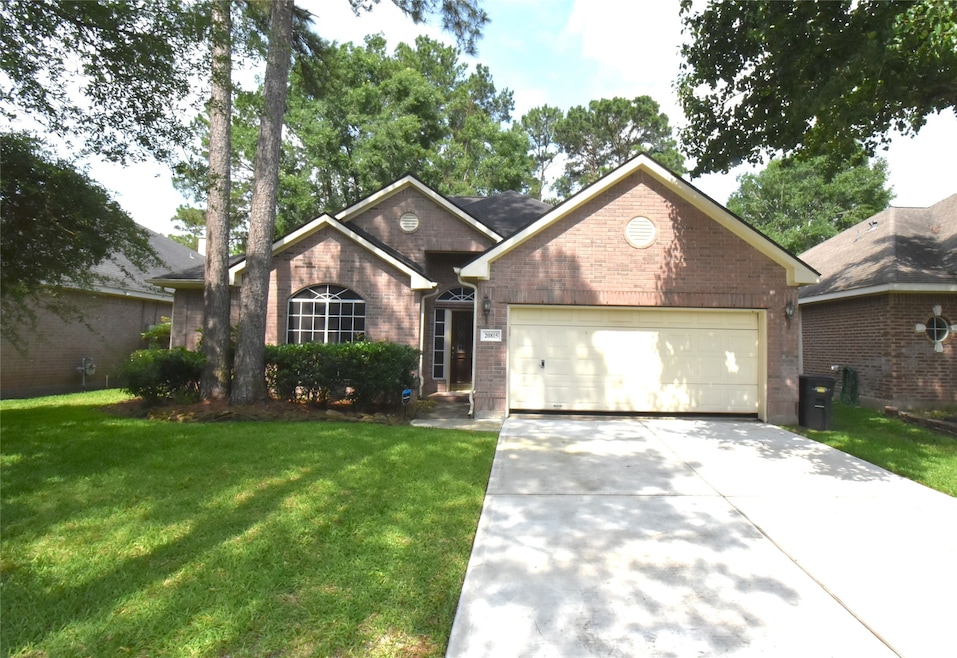 Charming brick home with a two-car garage and well