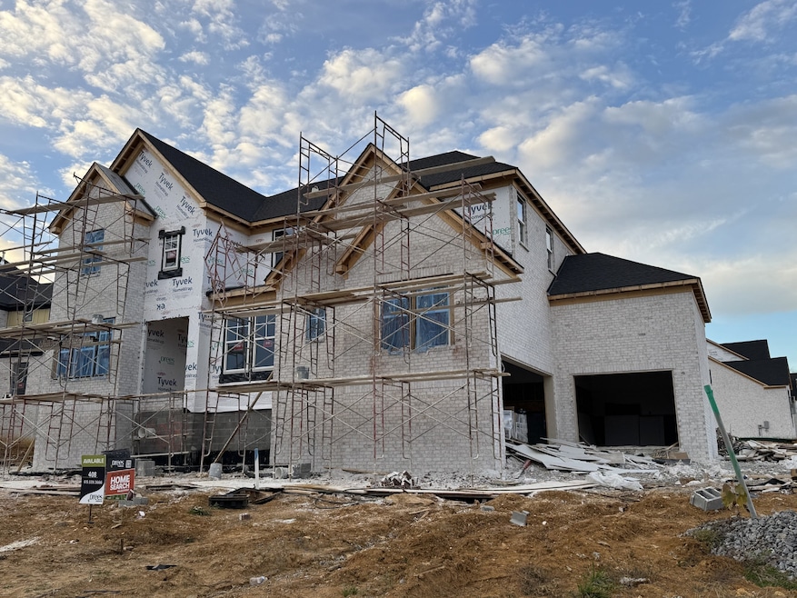 The Marshall in High Park Hill located on a wide corner homesite. Two car side entry garage with a one car carriage. Currently being drywalled. Photo taken October 24, 2025. Estimated completion February 2026.