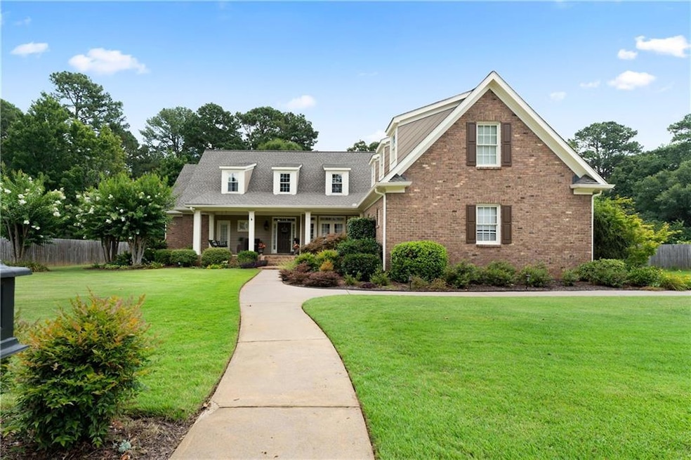 View of front of house featuring brick siding and a porch