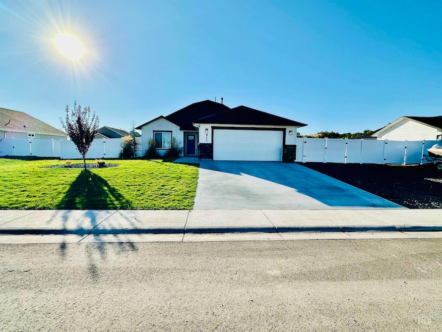 Ranch-style home with concrete driveway, a gate, and a garage