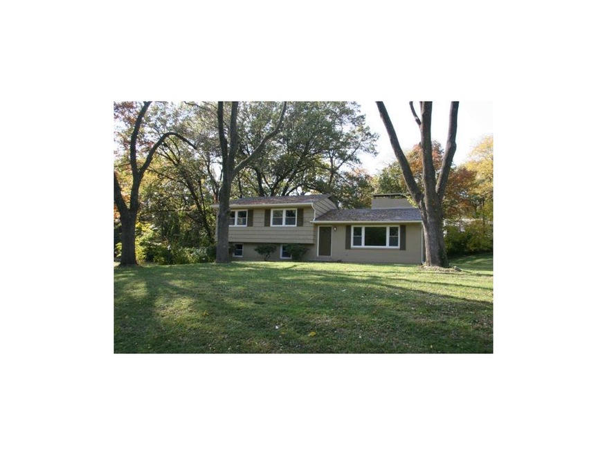 Front view with a large yard.