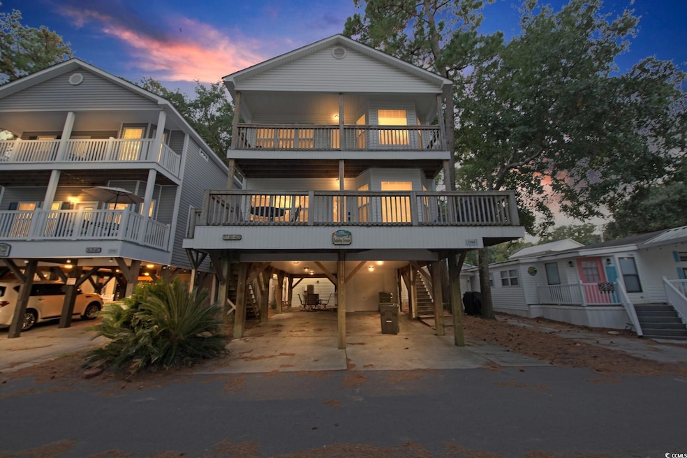 Back of house at dusk featuring a balcony, a carpo