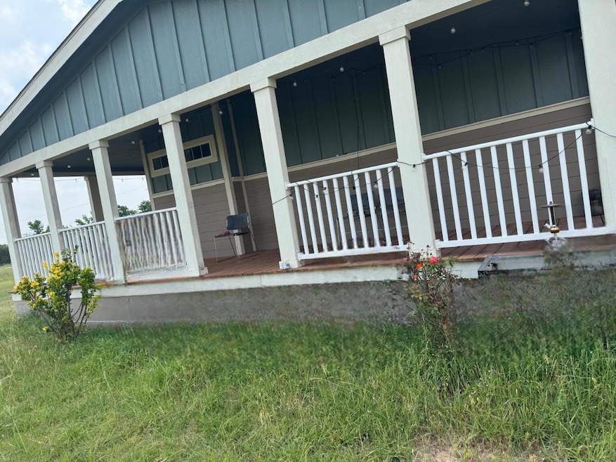 View of home's exterior with a porch and board an