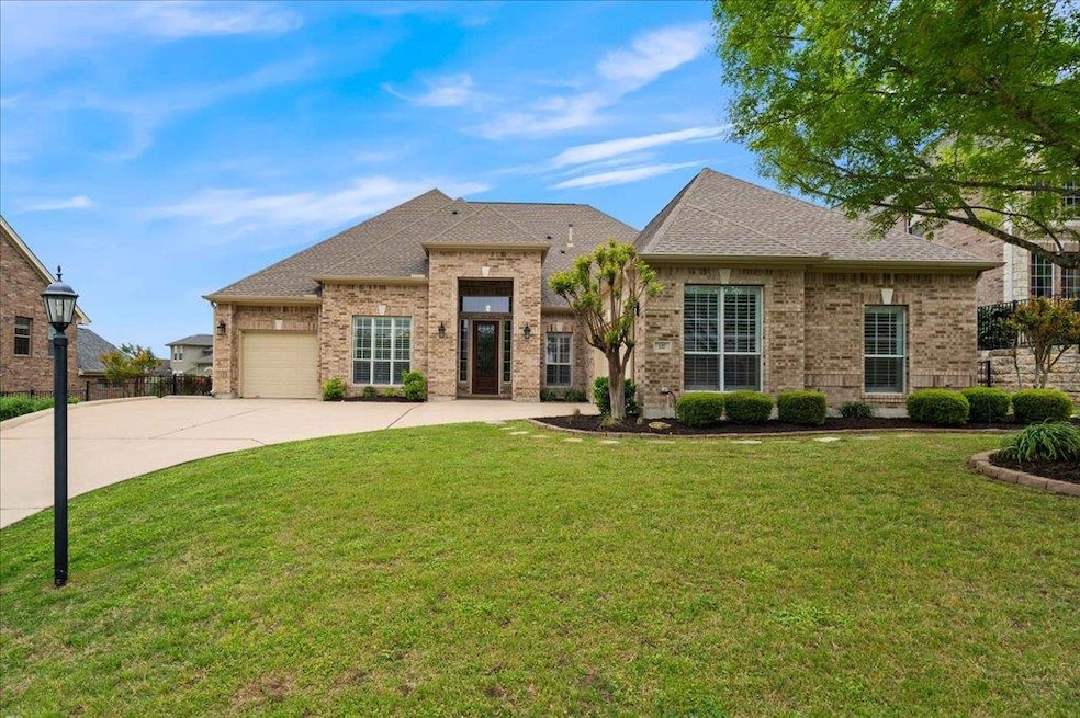 View of front of home with driveway, brick siding