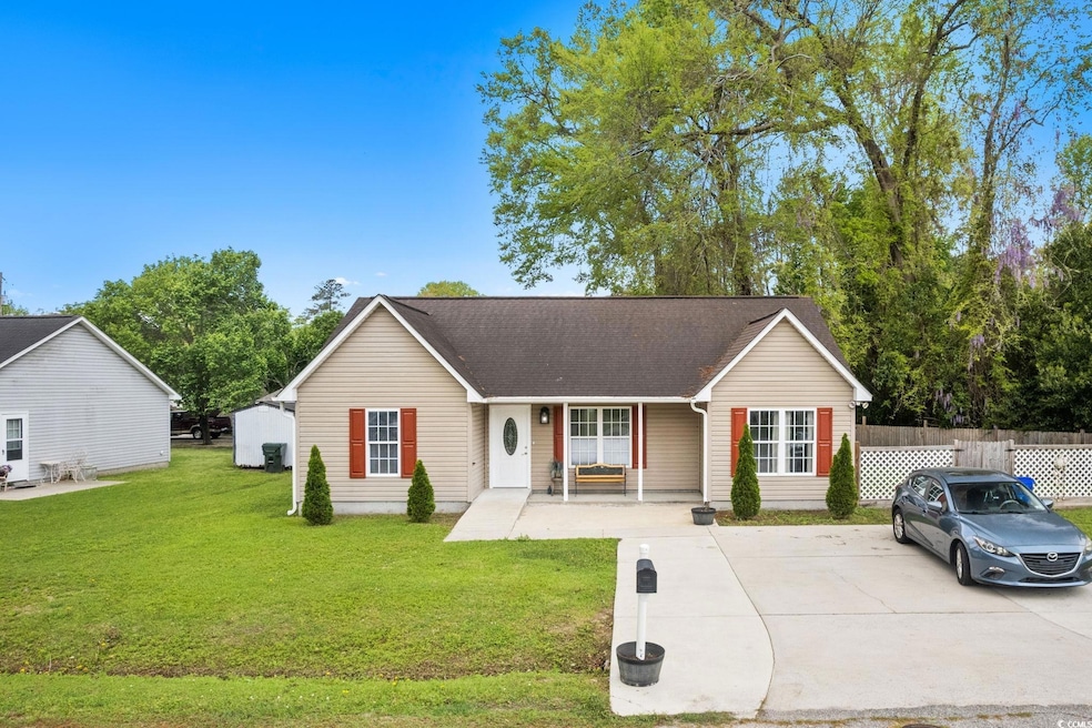 Ranch-style home featuring a front yard, roof with