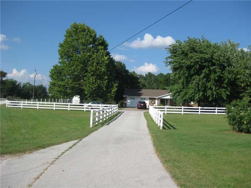 Exterior Front. A look down the driveway at this nice home with beautiful mature trees and nice fencing.