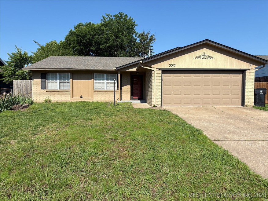 Ranch-style house with brick siding, a garage, and