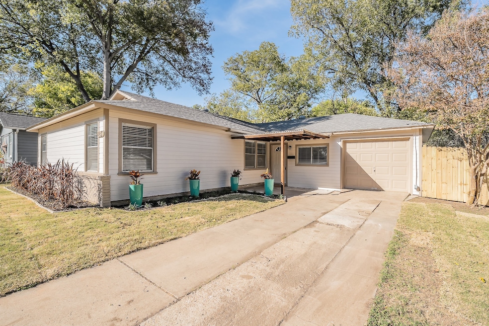 Single story home with a garage, driveway, and a shingled roof