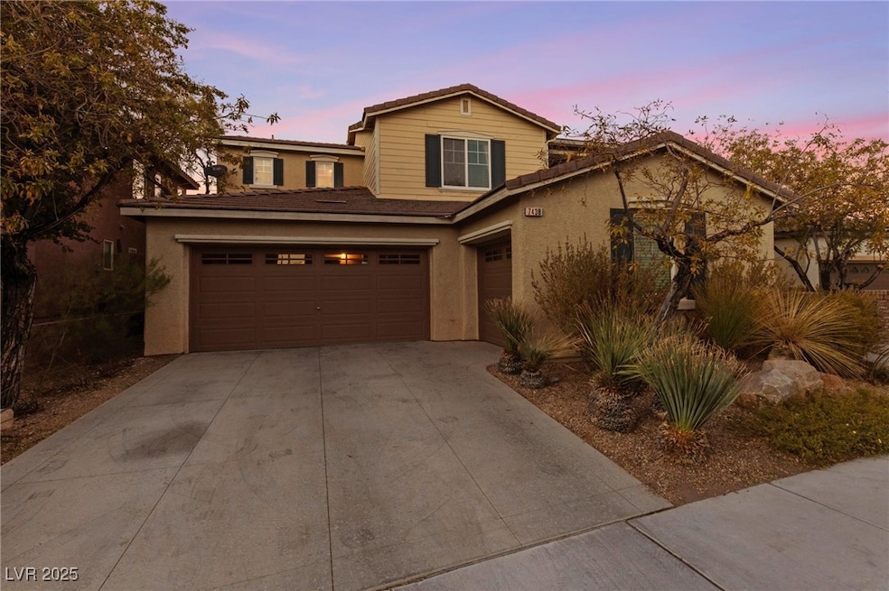 Traditional-style house with stucco siding, drivew
