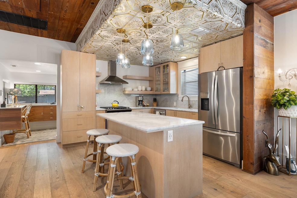 Kitchen with stainless steel refrigerator with ic
