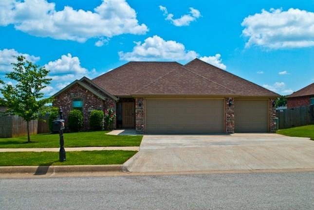 Welcome home! Beautiful manicured front yard with a THREE car garage