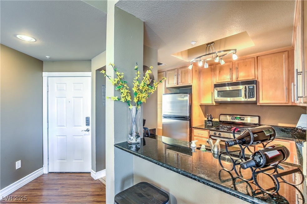 Kitchen featuring stainless steel appliances, dark