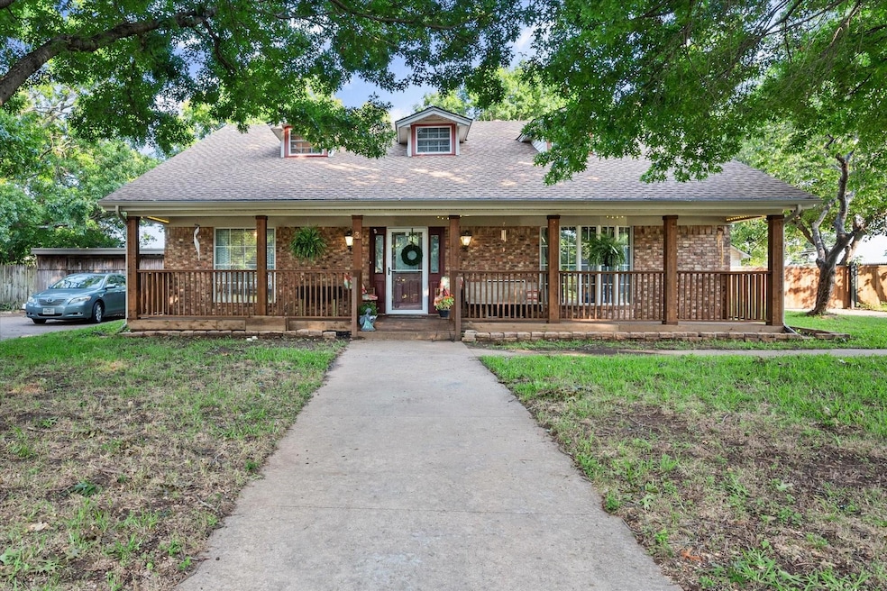 View of front of home with a front lawn and covere
