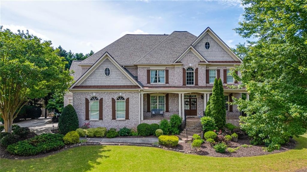 Craftsman house featuring a front lawn, a porch, brick siding, and roof with shingles