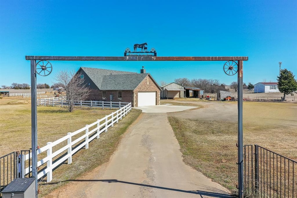 View of road featuring driveway and a gated entry