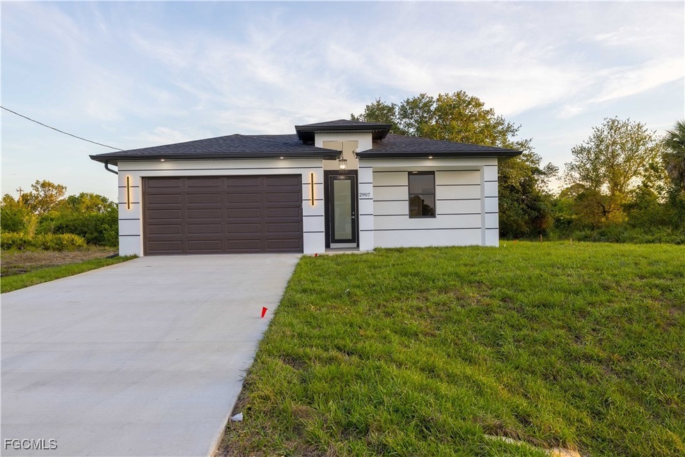 Prairie-style home with an attached garage, concrete driveway, a front yard, and stucco siding