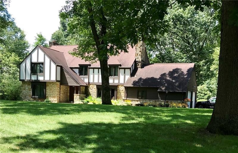Beautiful stone Tudor on awesome 2.43 acres. Recen