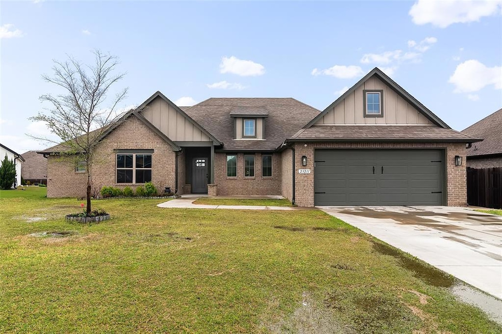 Craftsman-style home with brick siding, a garage, 
