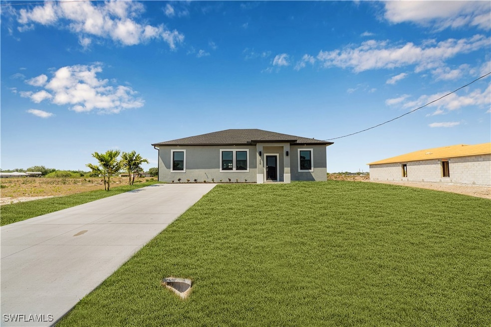 View of front of home with concrete driveway, a fr