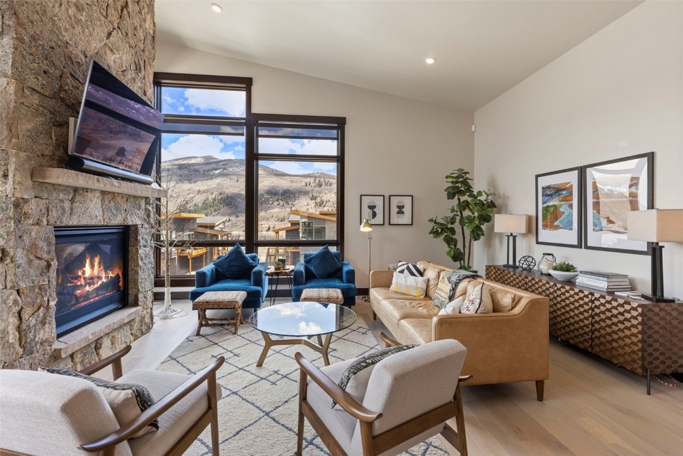 Living room featuring vaulted ceiling, a mountain
