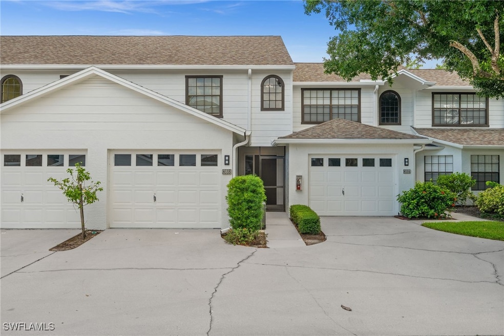 Traditional-style home with driveway and roof with