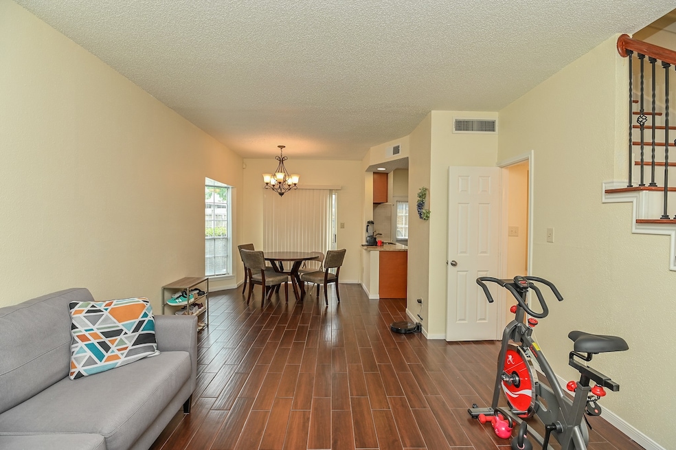 Spacious living room with wood-like tile.