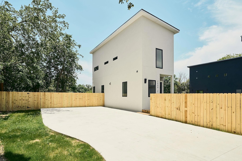 Rear view of property featuring stucco siding and