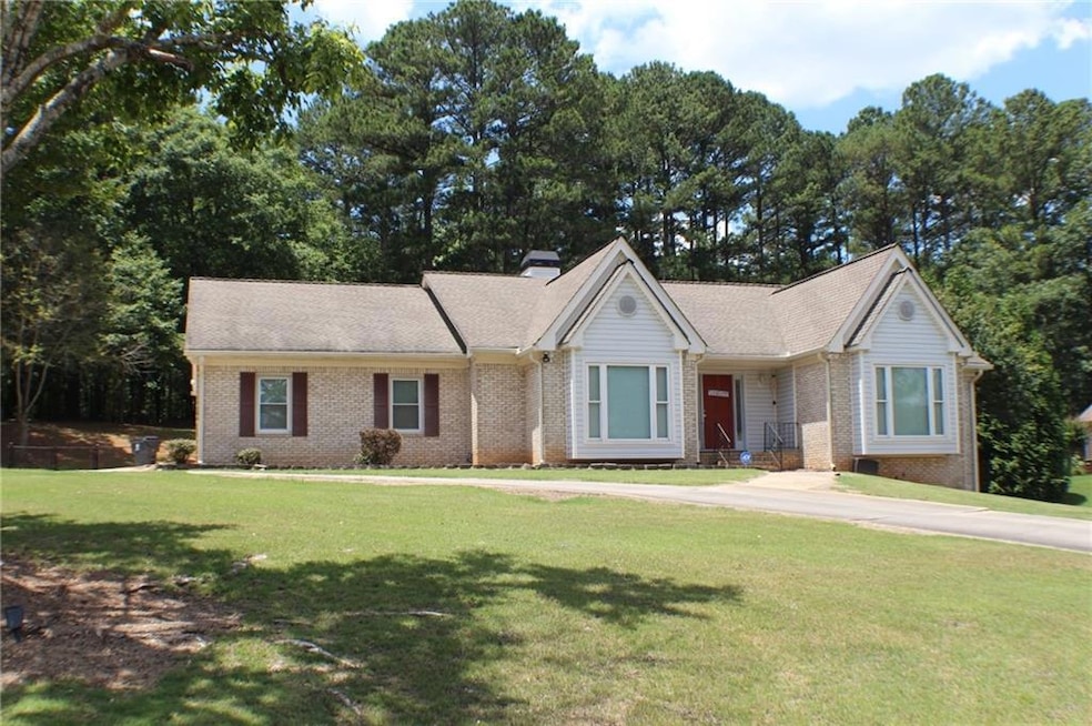 Ranch-style home featuring brick siding and a front lawn