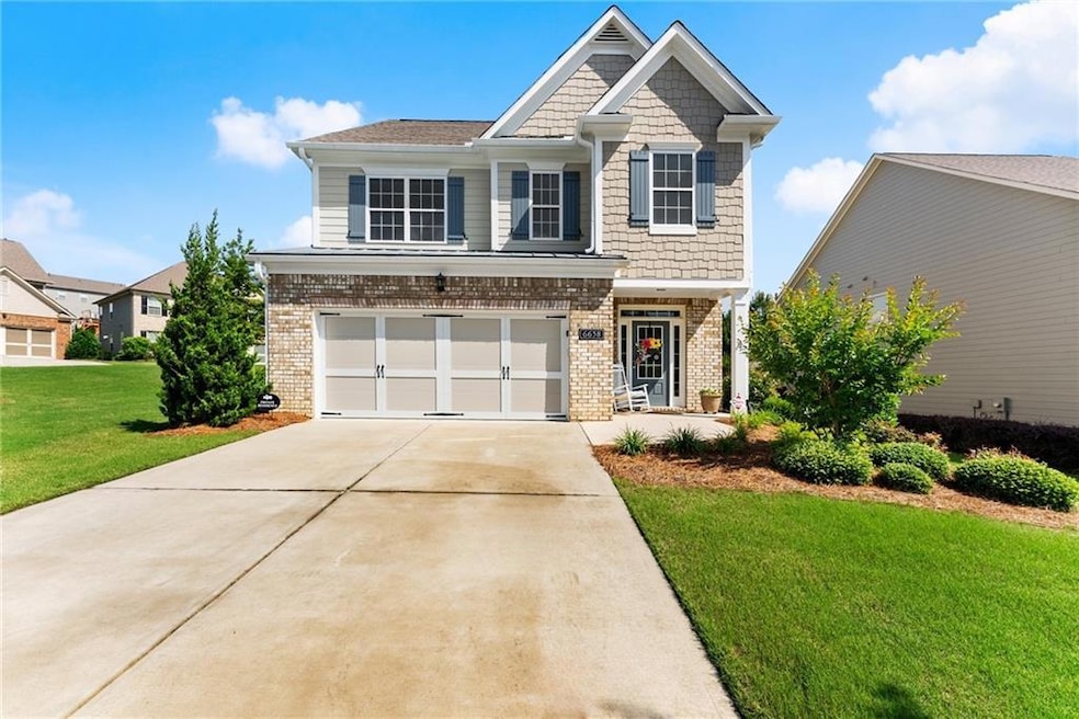 Craftsman-style house featuring brick siding, a ga