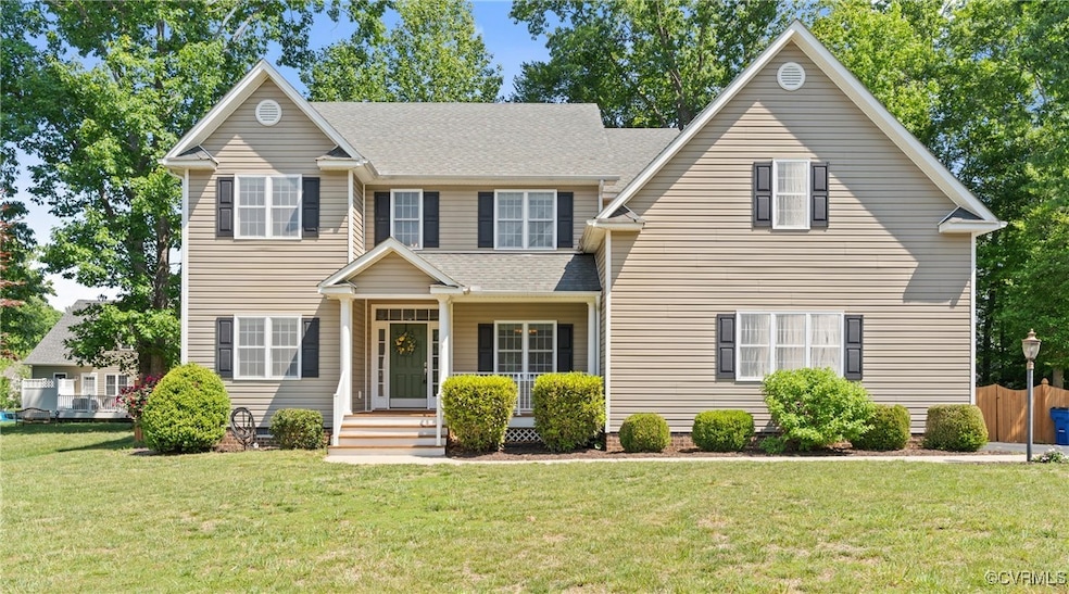 View of front of home featuring a front yard, a po