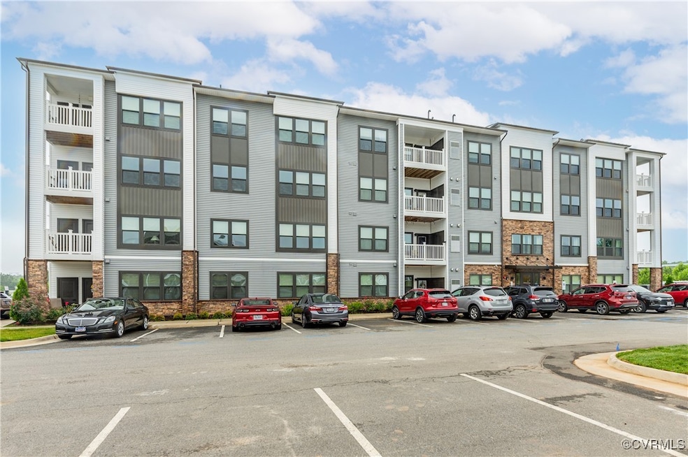 View of property featuring uncovered parking