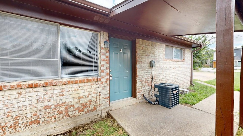 View of exterior entry with brick siding and centr