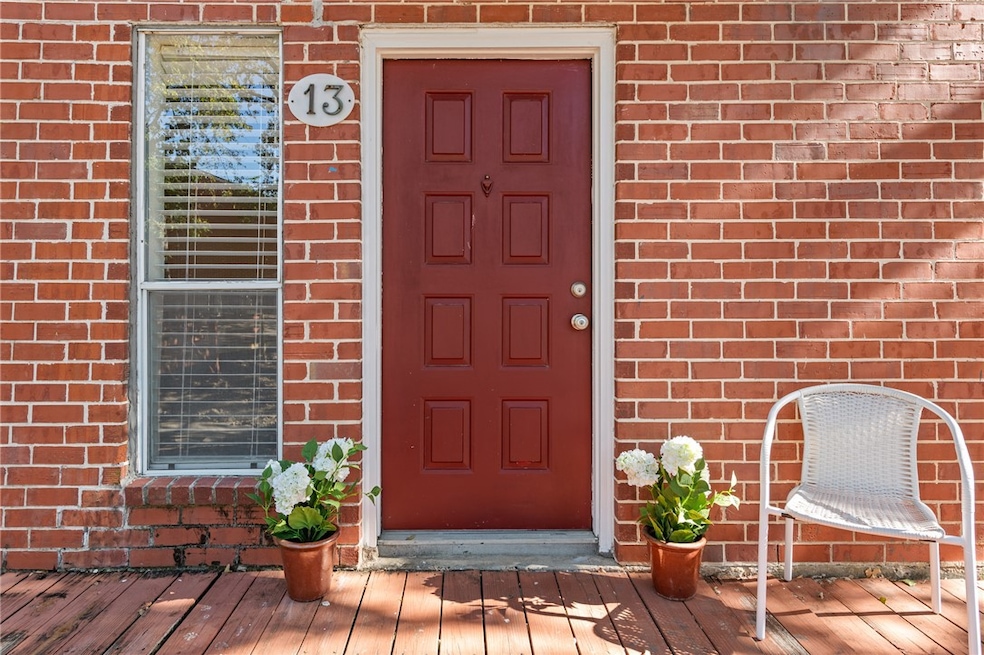 View of exterior entry featuring brick siding