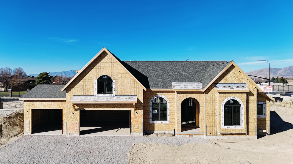 View of front of property with a mountain view, a shingled roof, driveway, and brick siding