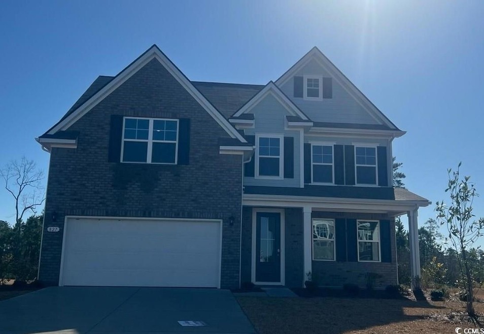View of front of home with brick siding, concrete 