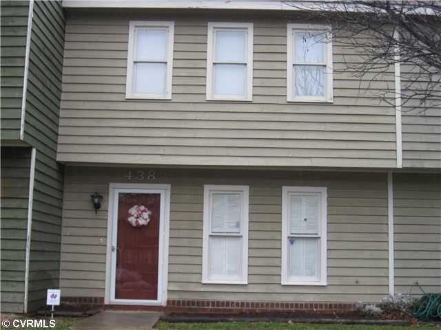 Exterior Front - Bright finished entrance and kitchen windows have cottage wood shutters and the overhanging 2nd floor gives great cover if raining