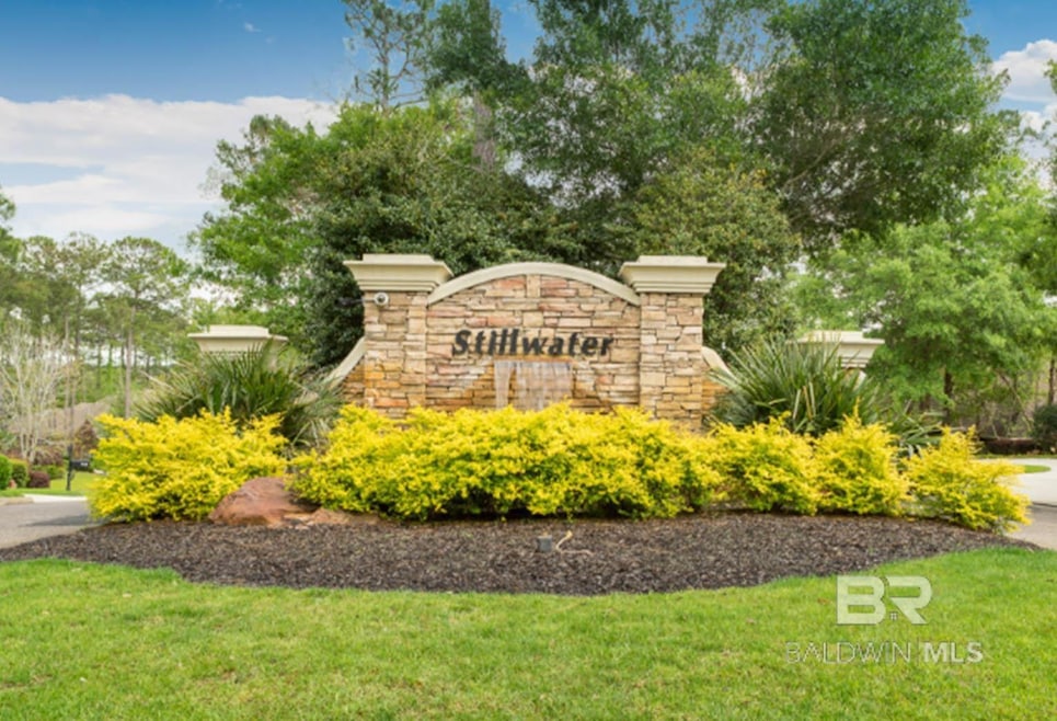 Community / neighborhood sign featuring a yard