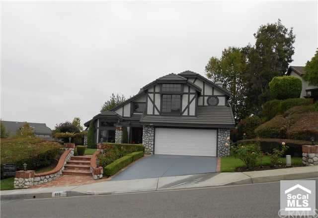 Front of home, beautifully landscaped corner lot
