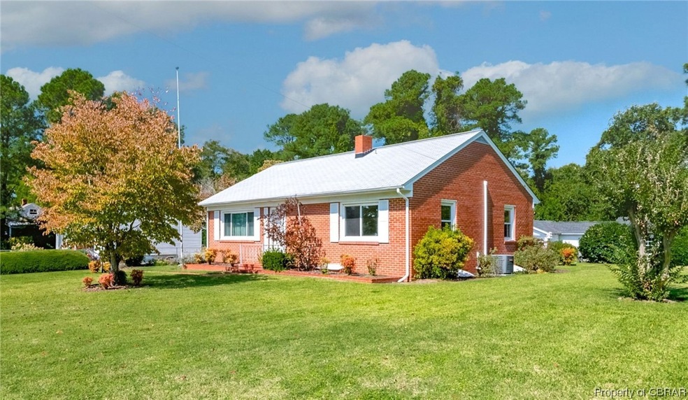 View of front of home featuring a front lawn and c
