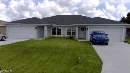 Ranch-style home with a garage, concrete driveway,