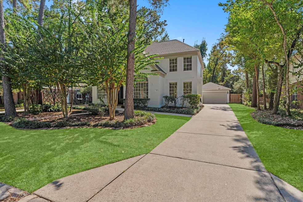 Framed by tall crepe myrtles, mature trees and lush greenery, this freshly painted brick residence stands out with its crisp, elegant exterior.