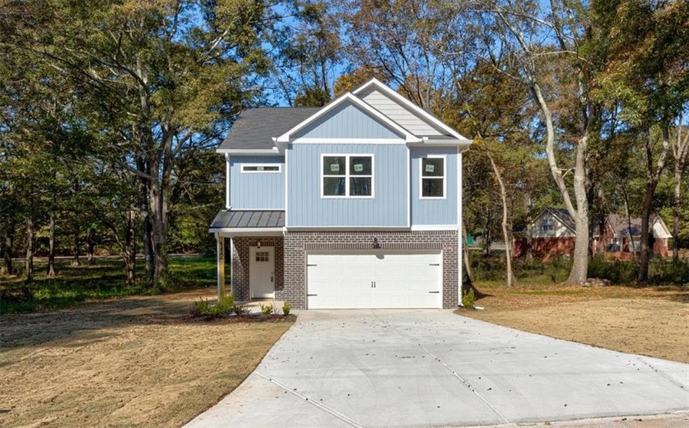 View of front facade featuring concrete driveway, 